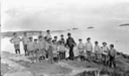 Group of Aboriginal children and a Priest from the Mission at Fort Chipewyan, Alberta n.d.