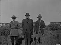 Inspector Bruce, Royal Canadian Mounted Police (R.C.M.P.), Conroy Indian Commissioner and Hugh Pearson, D.L.S. Fort Providence, N.W.T 1921