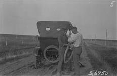 [Fixing a tire.] 1923