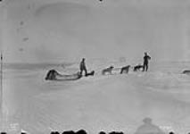 [Exploratory Survey between Great Slave Lake and Hudson Bay, Districts of Mackenzie and Keewatin.] Crossing rough ice with dogs and sled, Great Slave Lake, N.W.T