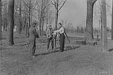 P.A. Carson and others measuring and reading Invar tape
