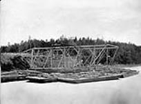 Construction of the Miramichi Bridges on the Intercolonial Railway. North West Branch. Side view of easterly abutment, with gantrey staging and traveller/Construction des ponts de Miramichi. Embranchement nord-ouest. Vue laterale de la butee avec echafau 21 Aug. 1872