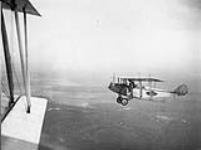 A chat about stability. Curtiss J.N.-4 in flight over Central Ontario c.a. 1918