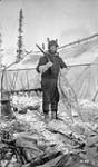 J.F. Fredette, D.L.S. 1st assit with cook tent in background 1915