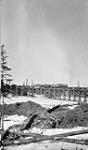 Work train taking water from standpipe on bridge over Pequitonary Pikwitonei River, about 212 miles from LePas on H.B. Railway, Man., 1915