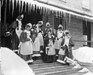 Lord Aberdeen's staff dressed as Schoolgirls for a masquerade skating party at Rideau Hall, called "Dame Marjorie School" February, 1894.
