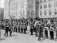 His Excellency [Viscount Willingdon] ispects the Governor General's Foot Guards drawn up on the Hill July 1927