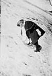Miss Vera Bury climbing the side of the mountain in winter 1910