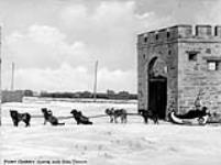 Fort Garry Gate and Dog Train ca. 1900-1925.