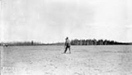 (Relief Projects - No. 17). Engineer checking grades on No. 1 runway May 1936