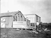 (Relief Projects - No. 19). Men erecting addition to horse barn Sept. 1935