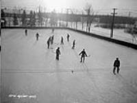 (Relief Projects - No. 21). Personnel playing hockey at Fort Osborne garrison rink Dec. 1933