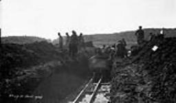 (Relief Projects - Excavation of the north-south runway with men loading the newly constructed narrow guage railway cars Sept. 1933