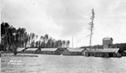 (Relief Projects - No. 51). Flooded buildings at Camp No. 8 June 1934