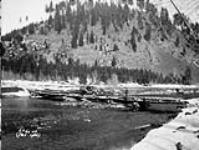 (Relief Projects - No. 60). A log bridge across the Moyie River built by the camp Jan 1934