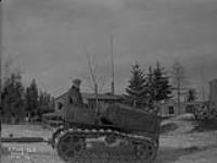 (Relief Projects - No. 103). Caterpillar tractor hauling gravel Feb. 1936