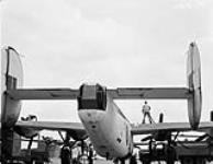 Groundcrew servicing a Consolidated Liberator aircraft of No.10(BR) Squadron, Royal Canadian Air Force (R.C.A.F.), Gander, Newfoundland, 29 July 1943 July 29, 1943.