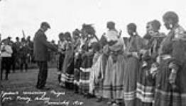Squaws receiving prizes for pony races, Punichy, [Sask.] 1914