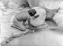 [A Hopi offering; north east Arizona]. Round, painted sticks with feathers attached by cotton cord are deposited in various places, such as springs and shrines, in supplication to the spirit associated with the locality 1922
