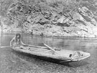 Yurok canoe on Trinity River, [California]. The canoe is a hollowed section of a redwood log 1924