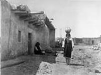 Sia street scene. [Sia is an eastern Keresan pueblo in New Mexico], on the north bank of Rio Jemez. Ancient Sia participated in the revolt of 1680. It was completely destroyed and had to be rebuilt. In 1924 the population numbered only 154 persons 1926