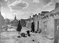 A street scene at San Juan, [a Tewa village lying in the Valley of the Rio Grande, New Mexico] 1926