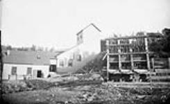Hardman's rock-crusher and concentrator and the skeleton of 3 batteries of an old mill, Oldham, N.S 1891