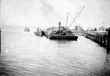 Lightering timber to dock at Churchill, Manitoba and temporary wharfage constructed to receive supplies for Harbour construction of 1928