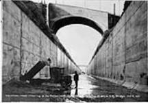 Dump truck clearing bottom of Hydro Electric Power Company Canal under Niagara, St. Catharines and Toronto Railway bridge, 5 Oct. 1921