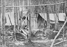 Two Ojibway men building a fire for their camp, Wenebegon Lake, Chapleau District, Ontario n.d.