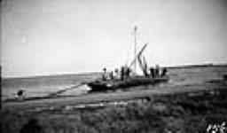 Bateau lowering sail, Ile-à-la-Crosse, Sask