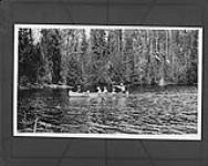 An Indian family travelling by canoe, Abitibi River, Ont