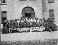 Group of students posing in front of the Brandon Indian Residential School, Brandon, Manitoba, 1946 1946.
