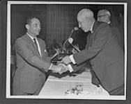 [John "Black Jack" Stewart (left) being inducted into the Hockey Hall of Fame by Clarence Campbell.] n.d.