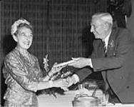 Mrs. Dorothy Walton being inducted into the Canadian Sports Hall of Fame by Harry Price. 1962 1962