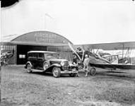 Aburn motor car with Travel Air 4000 aircraft CF-ABH at De Lesseps Aerodrome [ca. 1928].