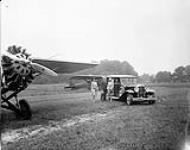 Auburn motor car with Travel Air 6000 aircraft CF-ABE and CF-AE1 at De Lesseyps Aerodrome 13 June 1929