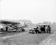 Auburn motor car with Travel Air 6000 aircraft CF-ABE at De Lesseps Aerodrome 13 June 1929