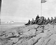 Hoisting the flag, Cape Herschel, Ellesmere Island, [N.W.T., August 11, 1904]