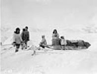 Group of Inuit standing around a Komatik, (sled), Wakeham Bay, Quebec [Nunavut], 1928 1928.