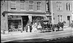 Wedding party in front of A.L. Handford Studio and store on Raglan Street ca. 1910