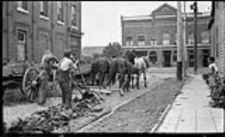 Men tearing up street ca. 1905 - 1915