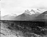 The Three Sisters and Wind Mountain looking over the Bow Valley, Banff National Park, Alta July 1926