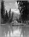 Boat houses on the Bow River [with] Mount Rundle [in the Background], Banff National Park, [Alta.], Oct. 1929