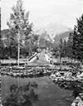 View from the Banff National Park Administration Building looking along the bridge over the Bow River and Banff Avenue toward Mount Cascade 1928