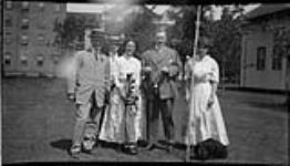Two couples of golfers posing in front of the Grand Hotel in Caledonia Springs 1900 - 1914