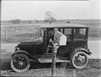 Rural mail courier collecting mail, November 26, 1926
