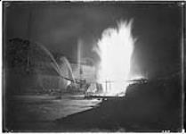 Gas well burning at night, Sarnia, [Ont.] 1901