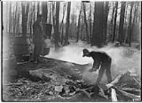 Boiling the sap in an open pan at a maple sugar bush, March, 1906 Mar., 1906