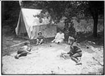 Camping at home - children playing in the sand, July 11, 1906 July 11, 1906.